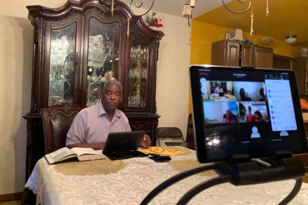 Pastor sitting at table