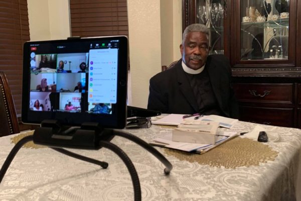 Pastor sitting at table